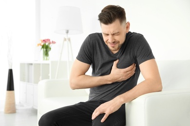 Photo of Mature man suffering from heart attack at home