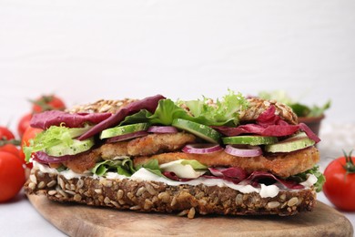 Photo of Delicious sandwich with schnitzel on table against white background, closeup