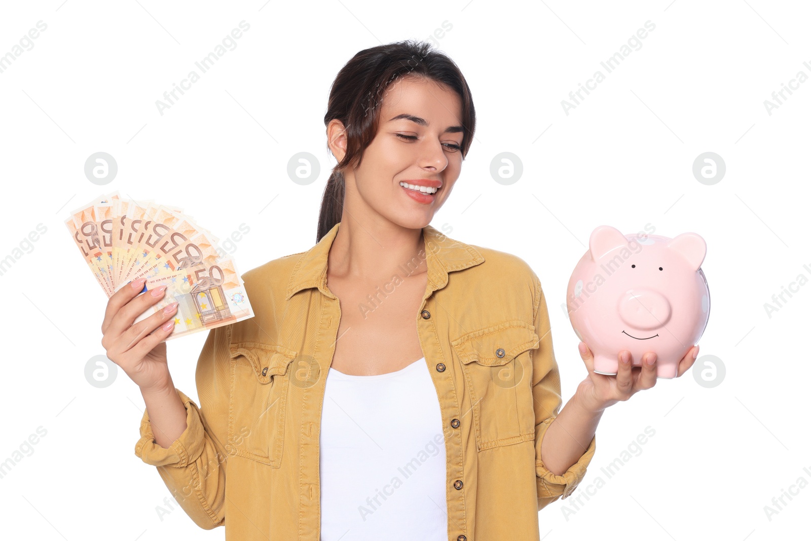 Photo of Young woman with money and piggy bank on white background