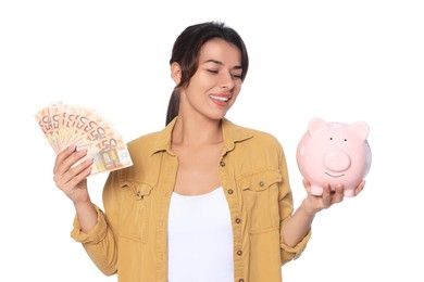 Young woman with money and piggy bank on white background