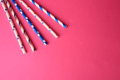 Photo of Paper drinking straws on pink background, flat lay Space for text