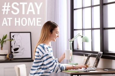 Image of Hashtag Stay At Home - protective measure during coronavirus pandemic. Teenage girl studying using laptop at table in her room