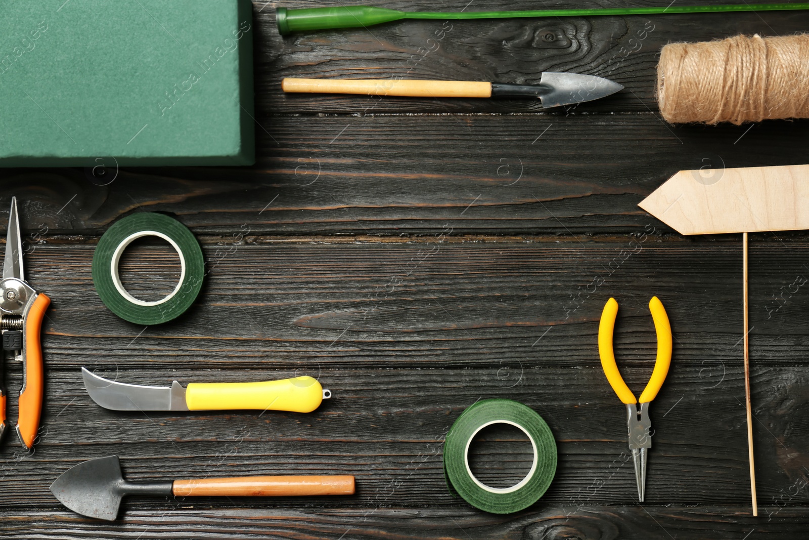 Photo of Florist equipment on wooden background, top view