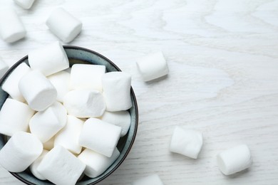 Photo of Delicious puffy marshmallows on white wooden table