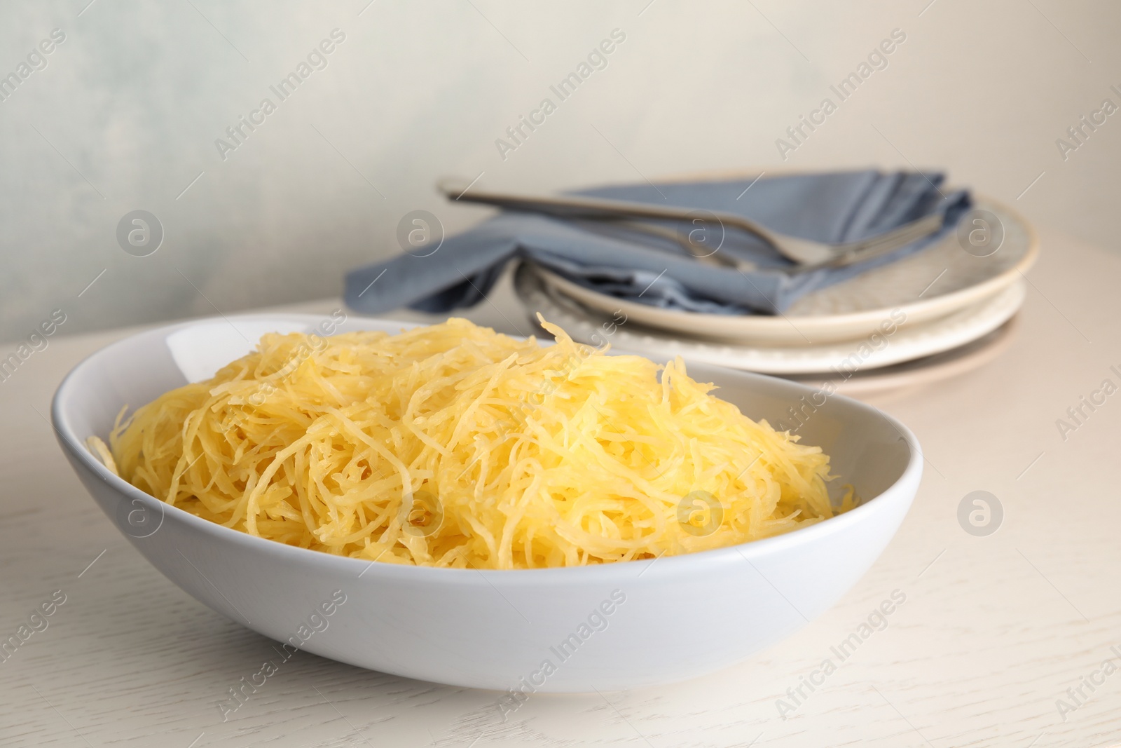 Photo of Cooked spaghetti squash in bowl on table