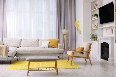 Photo of Spring atmosphere. Stylish room interior with cozy furniture in yellow and white colors