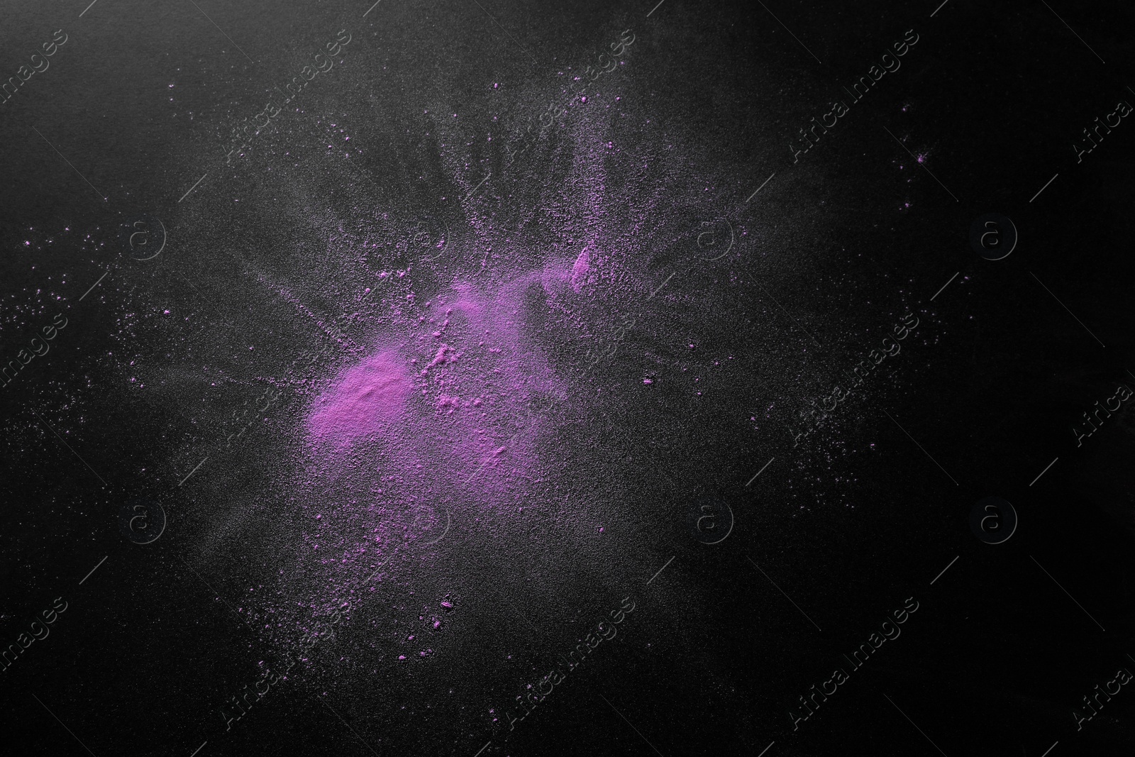 Photo of Violet powder dye on dark background, top view with space for text. Holi festival