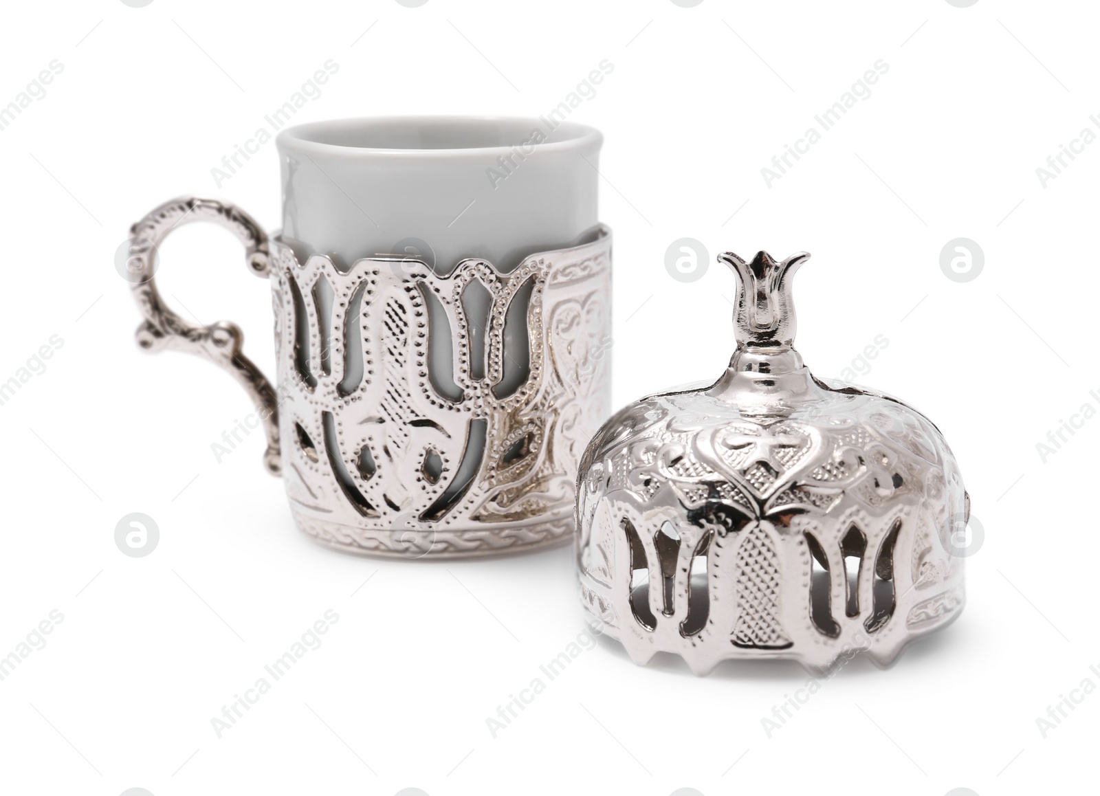 Photo of One ceramic cup in vintage holder and lid isolated on white
