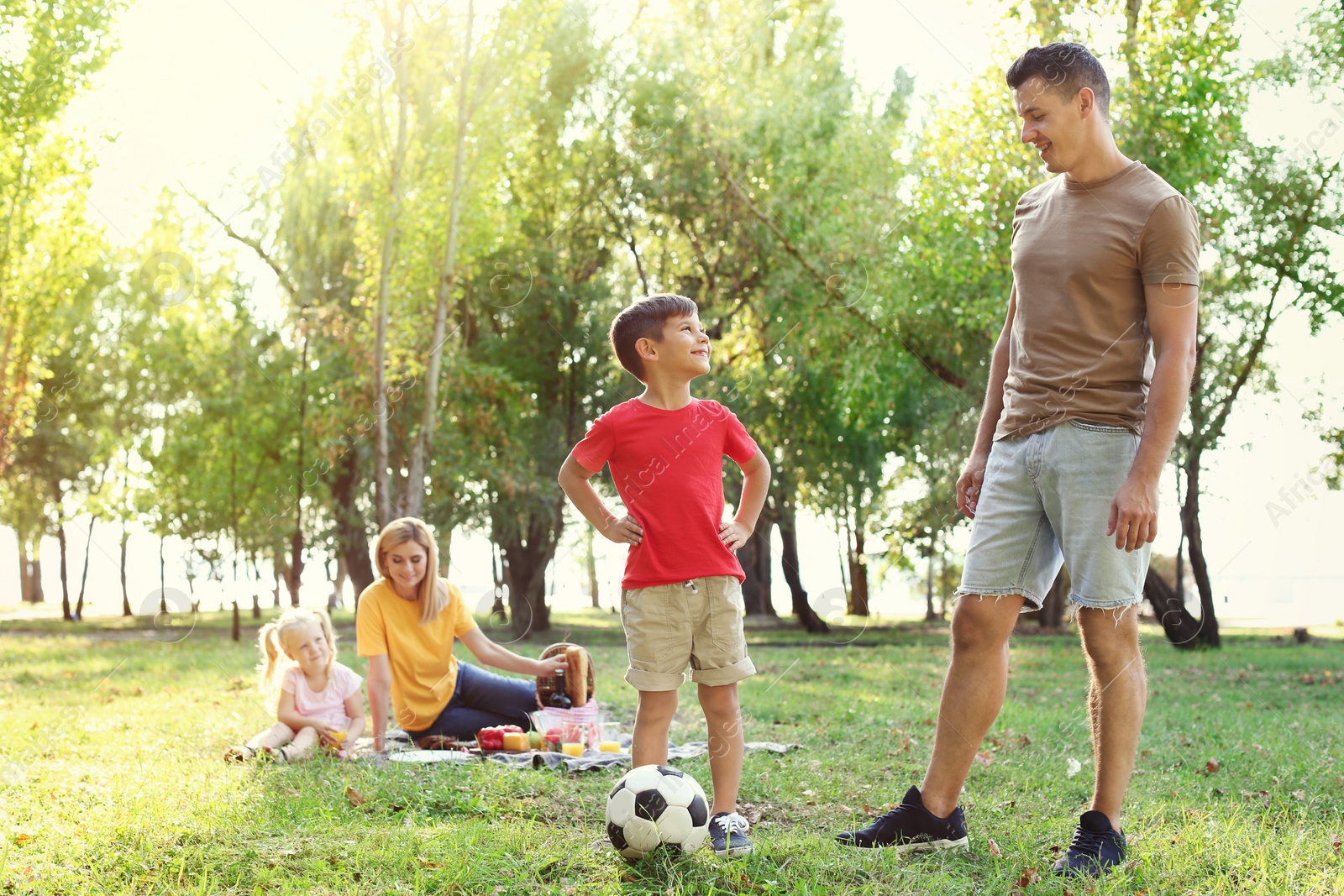 Photo of Happy family having picnic in park on sunny day