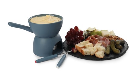 Photo of Fondue with tasty melted cheese, forks and different snacks isolated on white