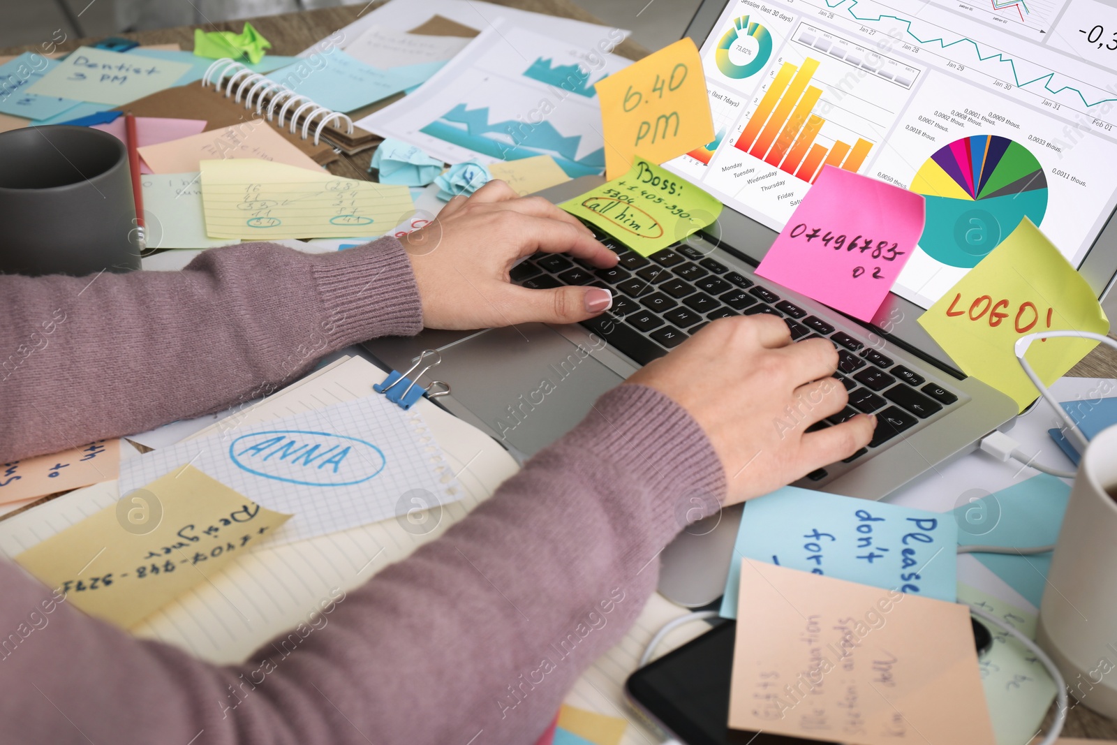 Photo of Overwhelmed woman working at messy office desk, closeup