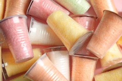 Photo of Plastic cups with cotton candy as background