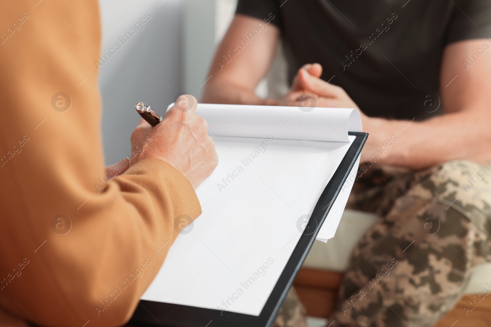 Photo of Psychologist working with military officer in office, closeup