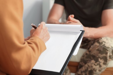 Psychologist working with military officer in office, closeup