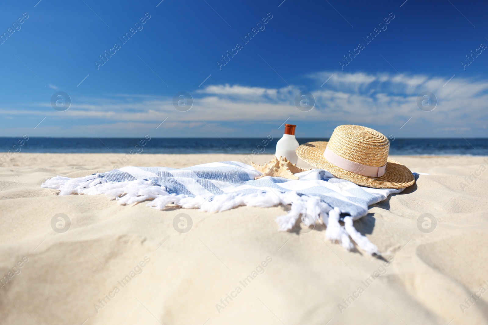 Photo of Stylish beach accessories for summer vacation on sand near sea