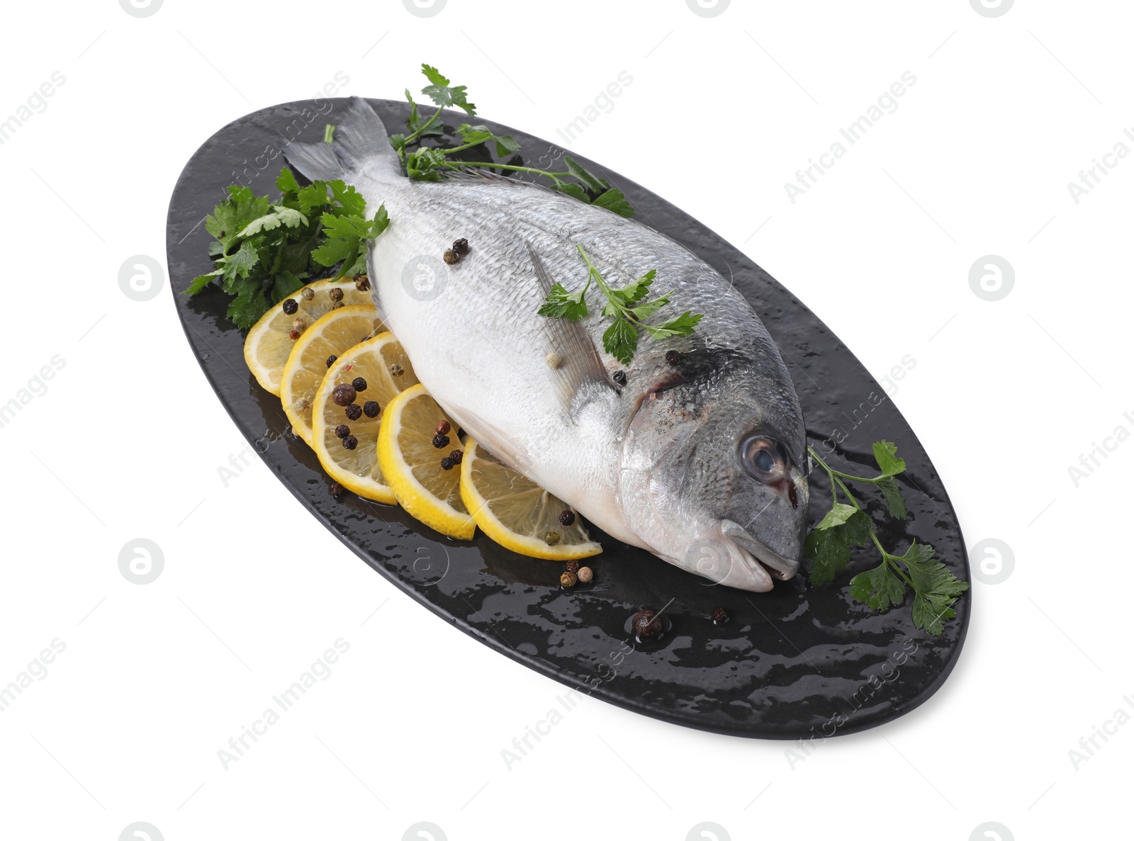 Photo of Raw dorado fish, parsley, lemon slices and peppercorns isolated on white