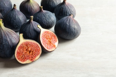 Bunch of fresh ripe figs on light background. Tropical fruit