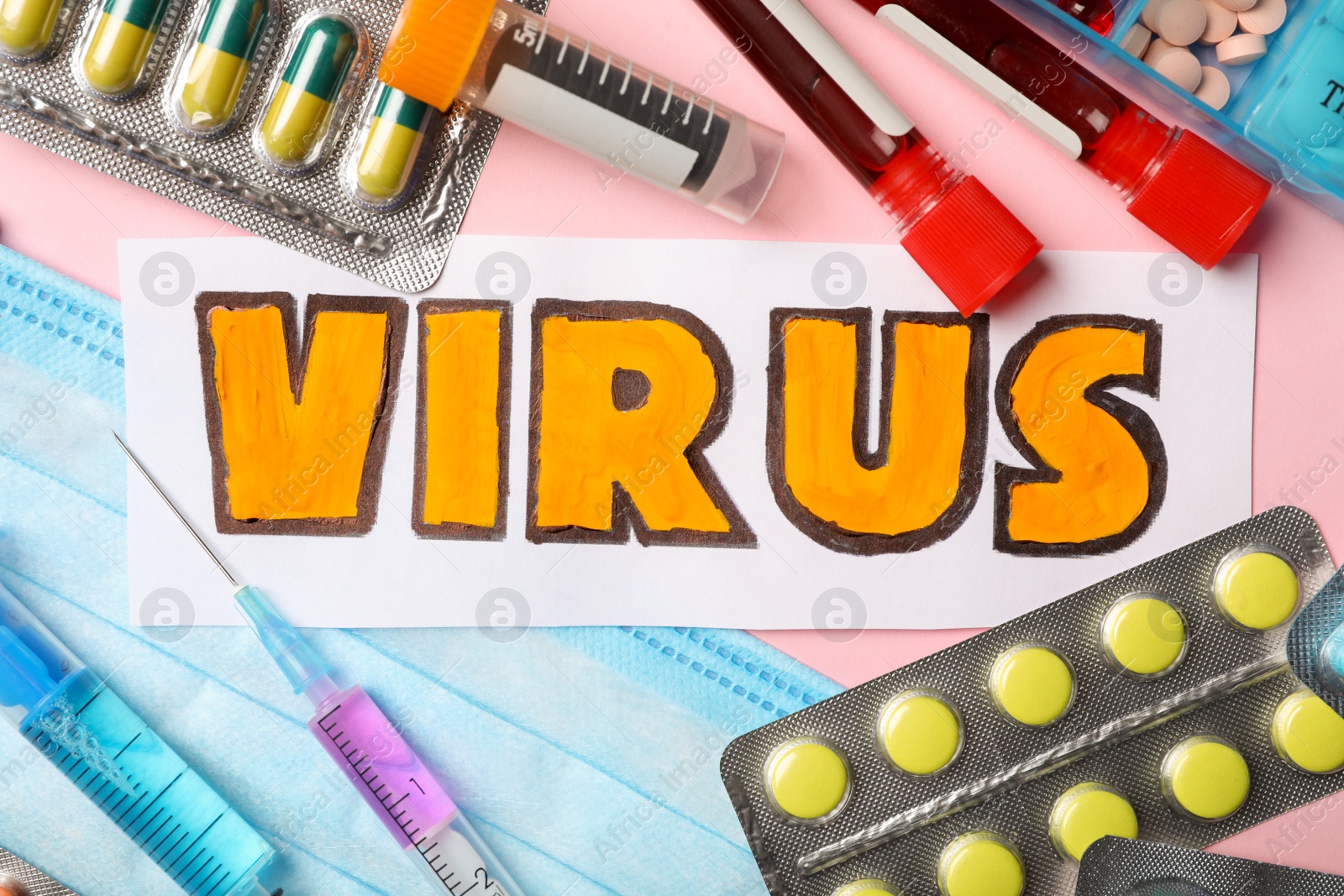 Photo of Flat lay composition with word VIRUS and medicines  on pink background