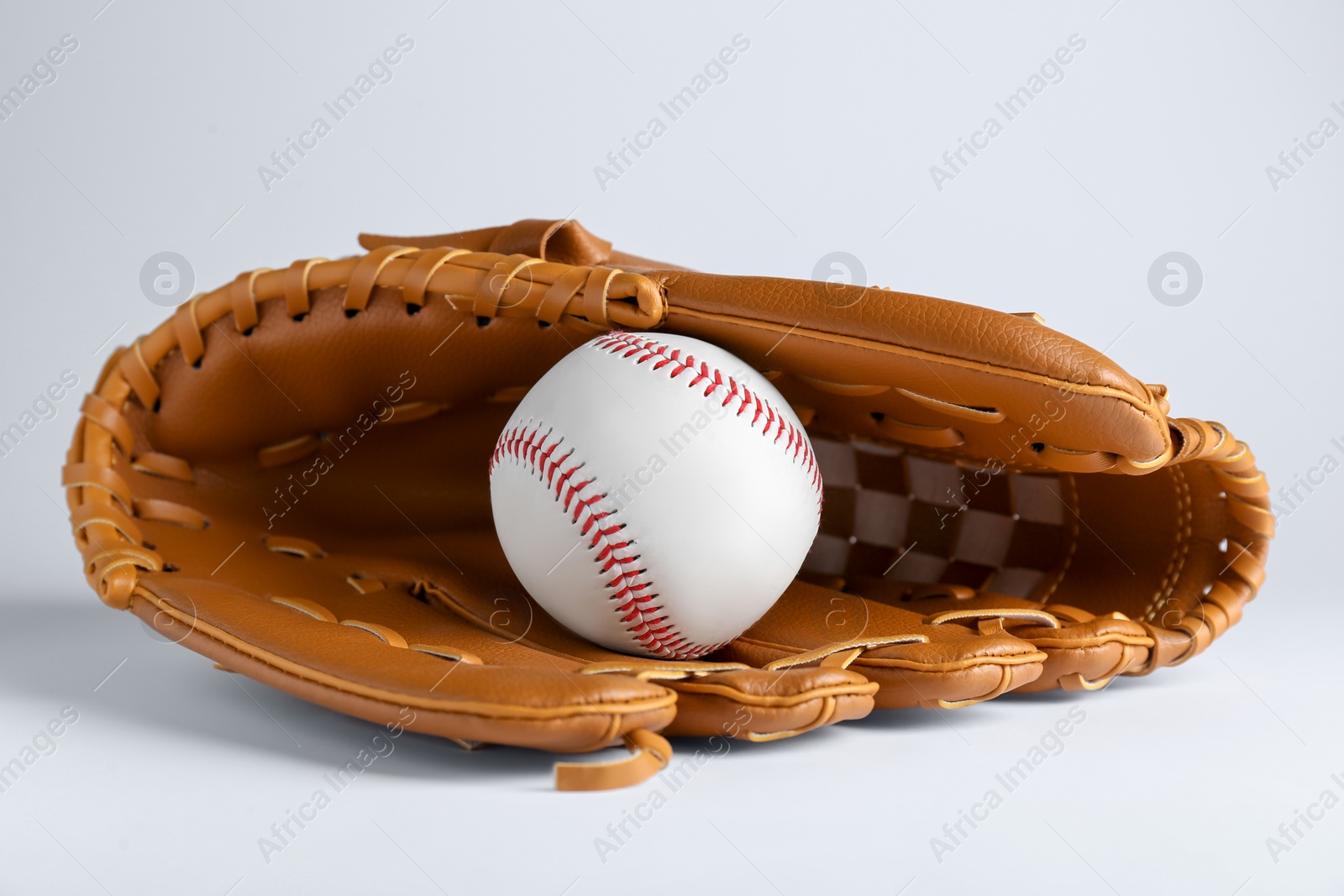 Photo of Catcher's mitt and baseball ball on white background. Sports game