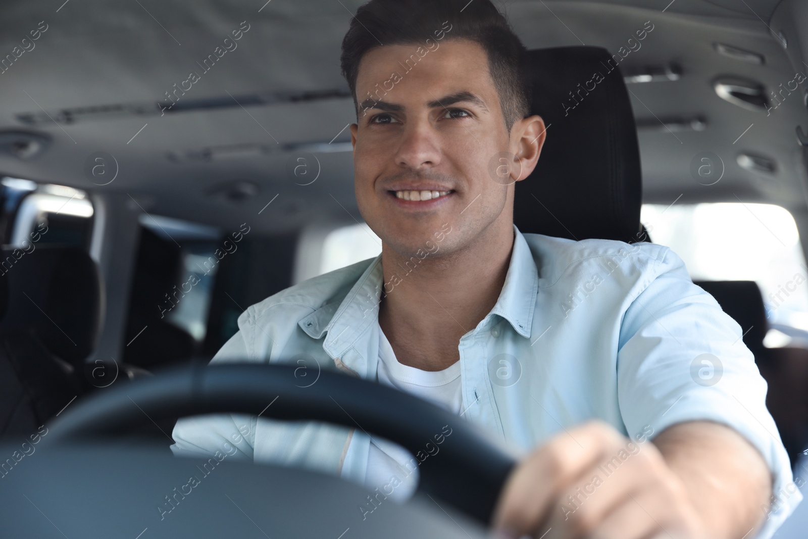 Photo of Handsome man driving his new modern car
