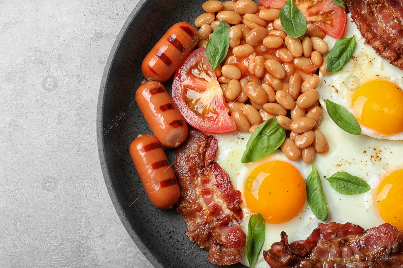 Photo of Delicious breakfast with fried eggs served on grey table, closeup