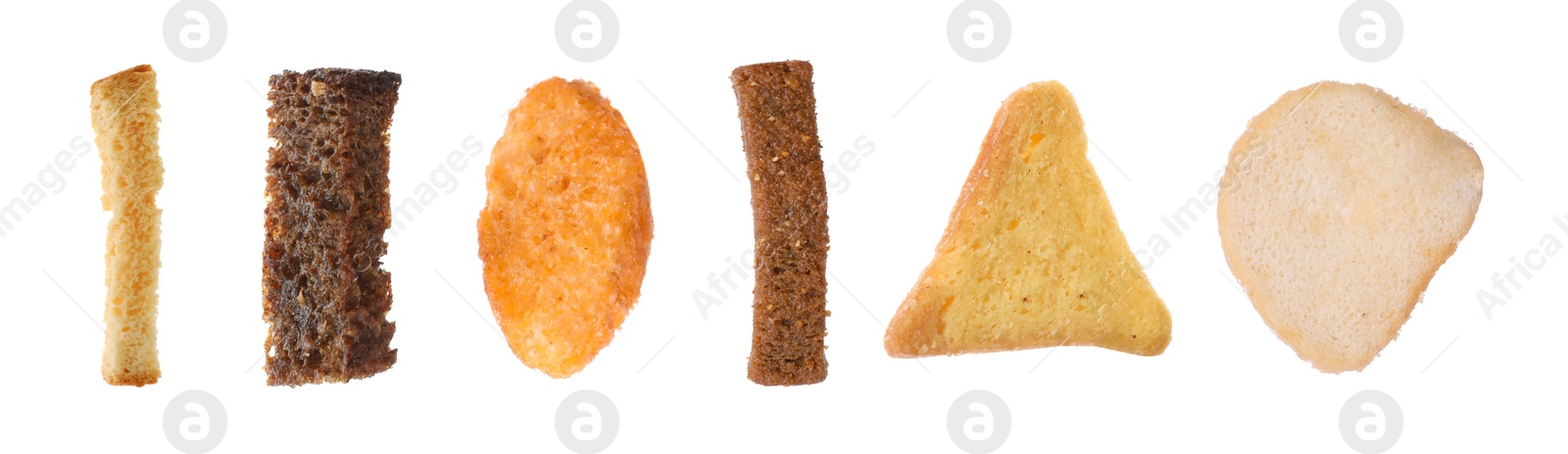 Image of Set with different delicious crispy rusks on white background. Banner design