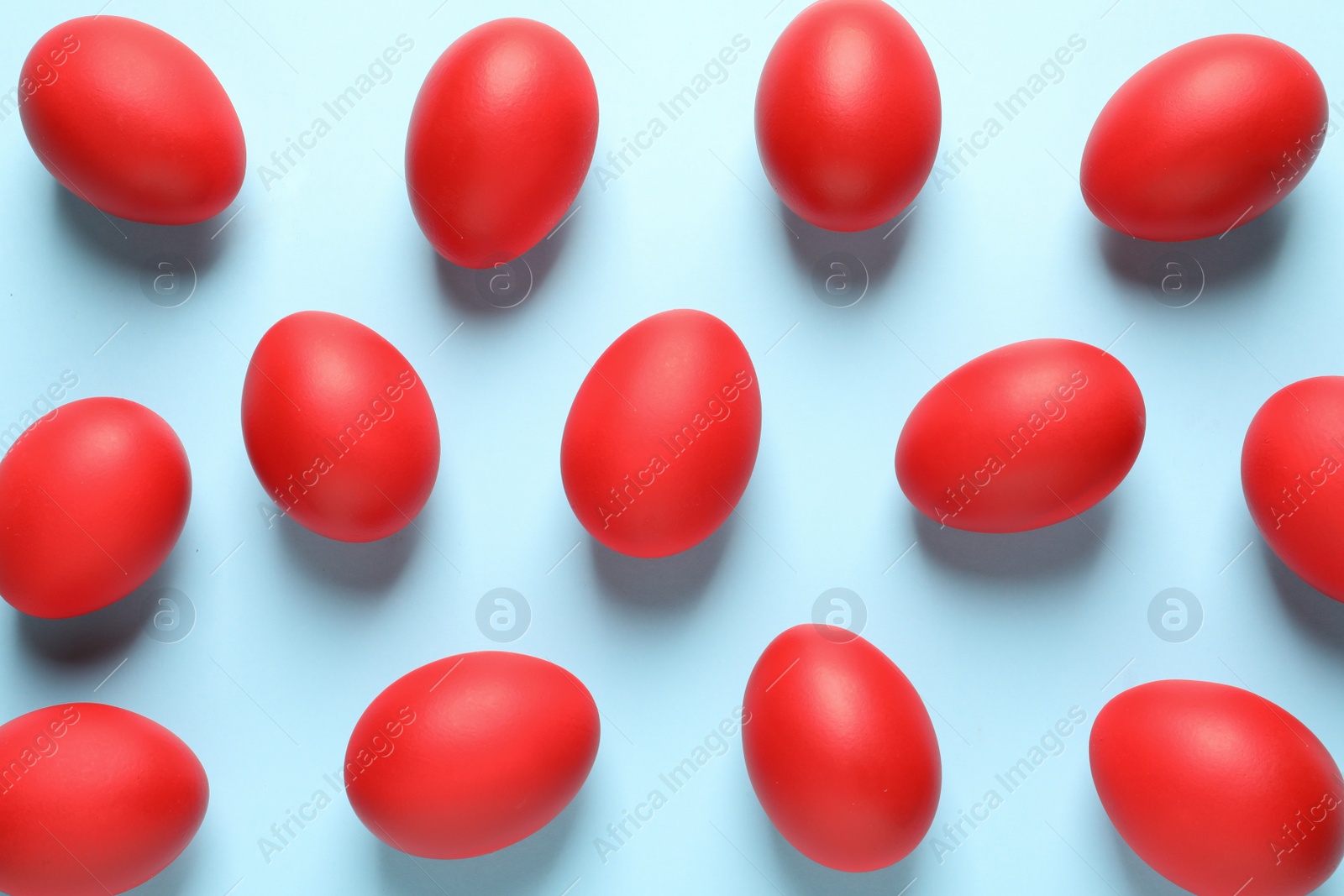 Photo of Flat lay composition of red dyed Easter eggs on color background