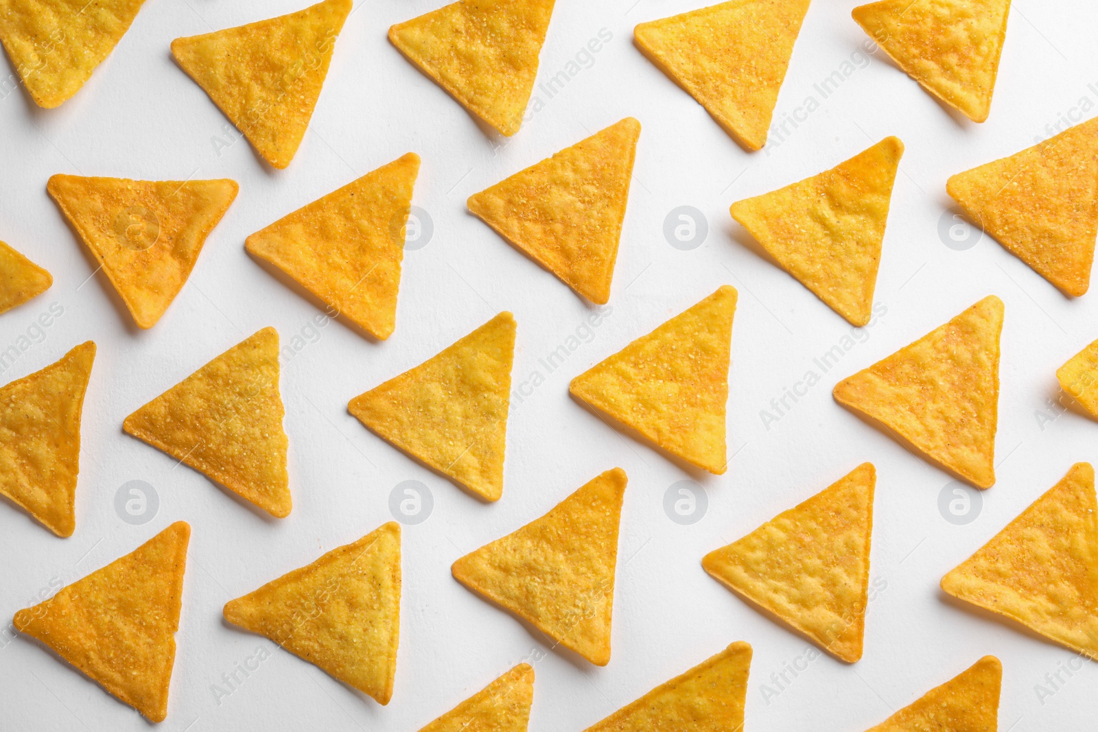 Photo of Flat lay composition of tortilla chips (nachos) on white background