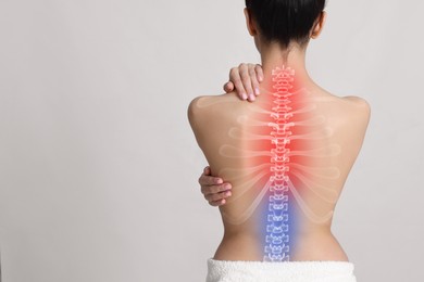 Image of Woman suffering from pain in neck on light background, space for text