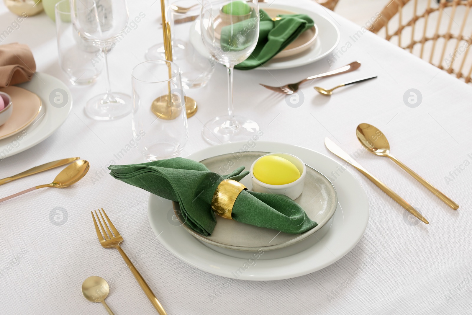 Photo of Festive Easter table setting with painted eggs