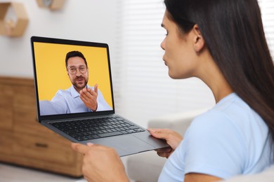 Image of Long distance love. Woman having video chat with her boyfriend via laptop at home