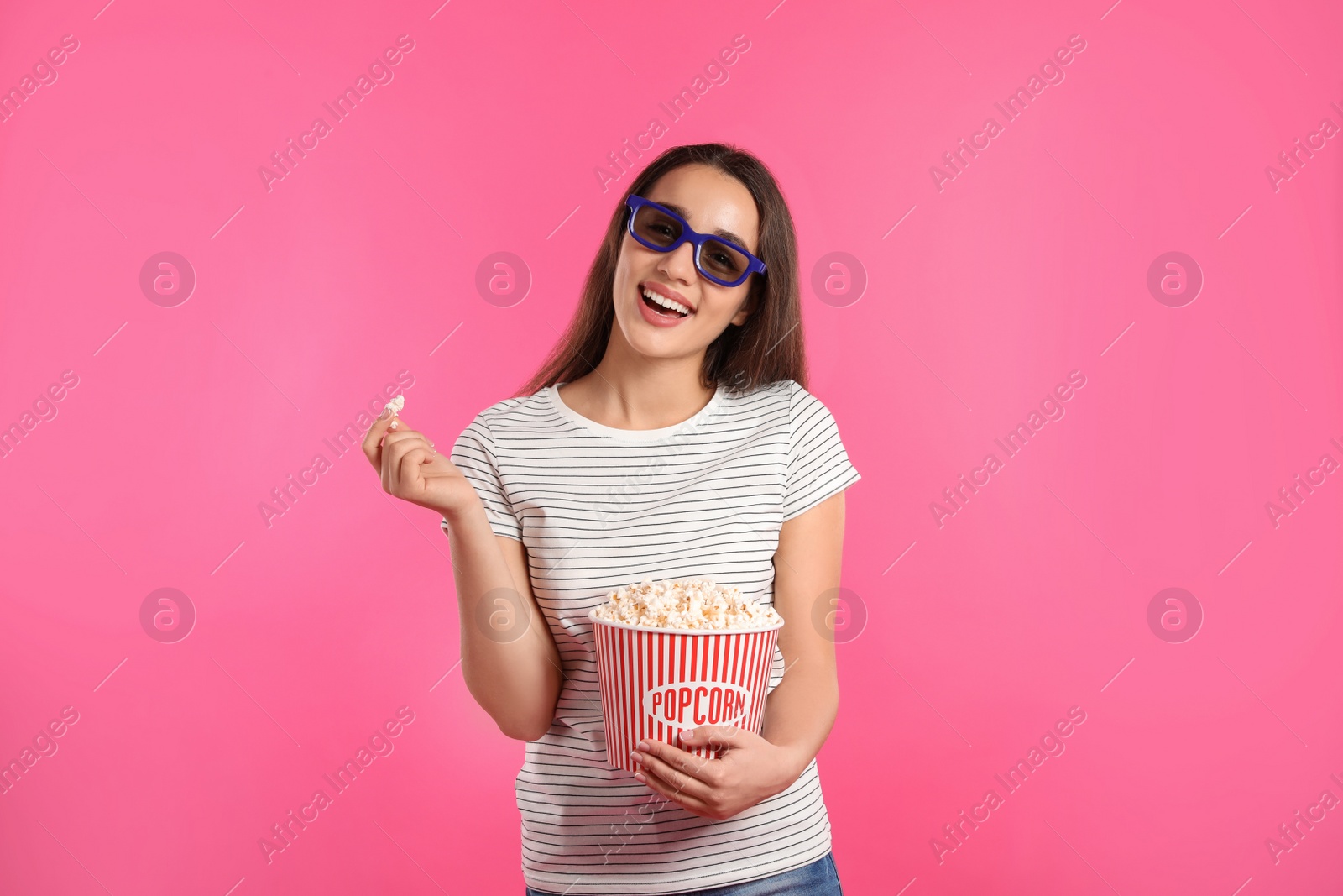 Photo of Woman with 3D glasses and popcorn during cinema show on color background