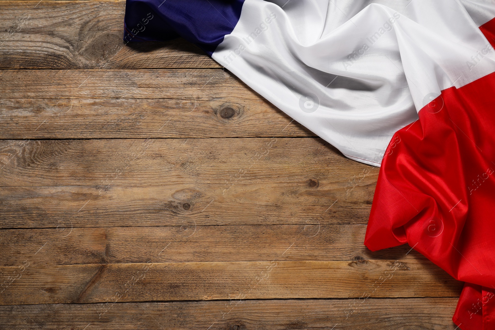 Photo of Flag of France on wooden background, top view. Space for text