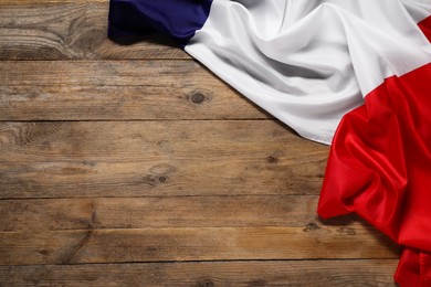 Flag of France on wooden background, top view. Space for text