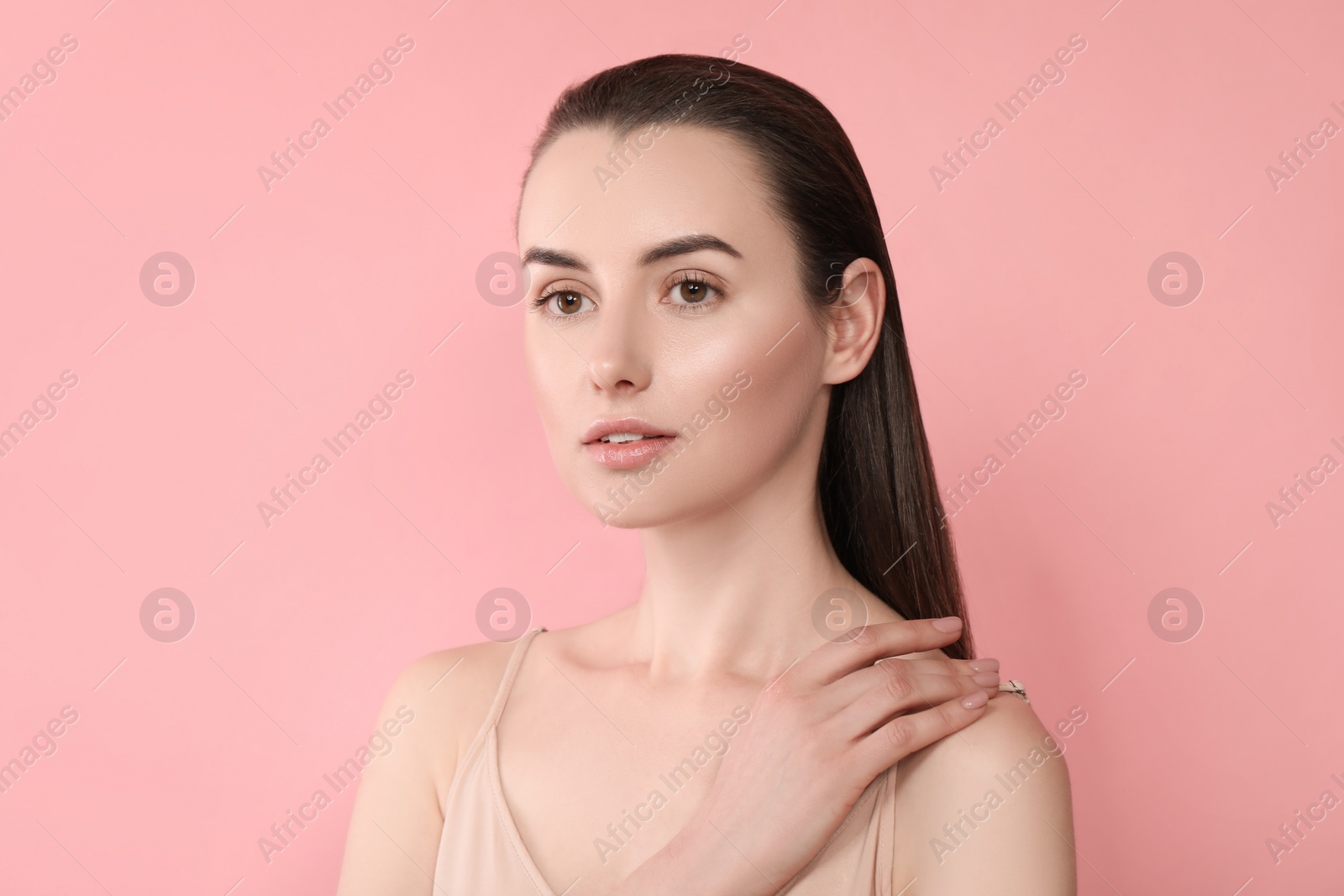 Photo of Portrait of beautiful young woman on pink background