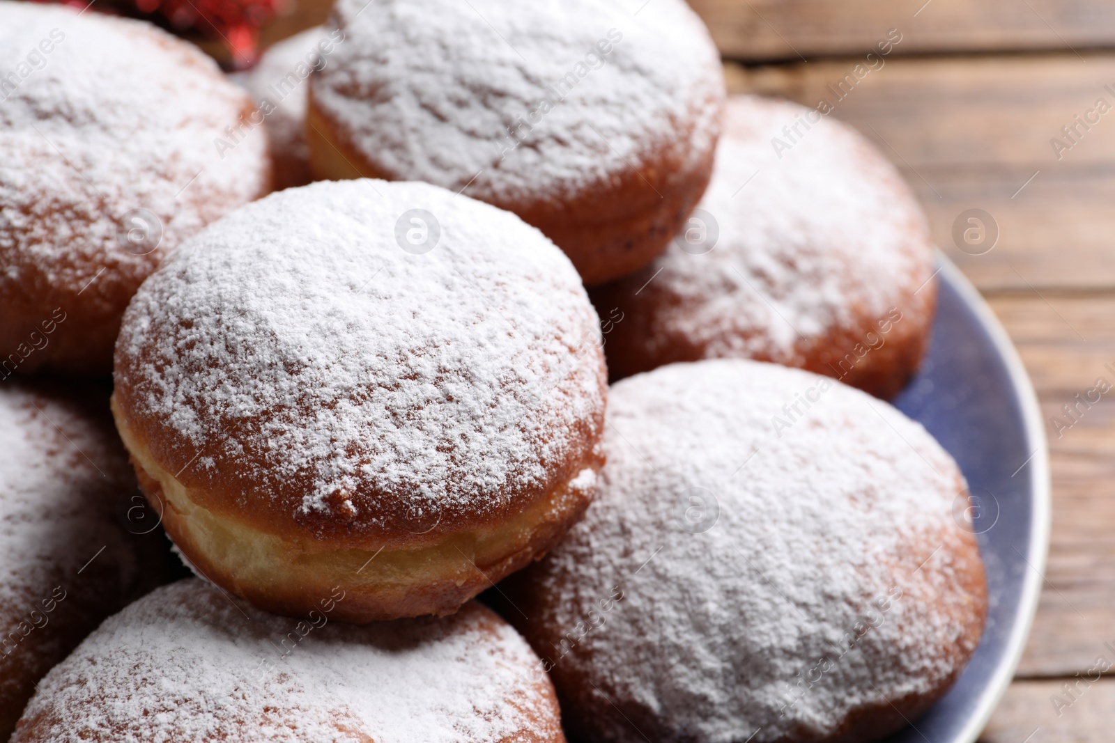 Photo of Delicious sweet buns with powdered sugar on table, closeup