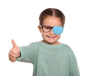 Photo of Happy girl with nozzle on glasses for treatment of strabismus showing thumbs up against white background. Space for text