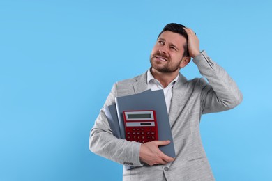 Photo of Confused accountant with calculator and folders on light blue background. Space for text
