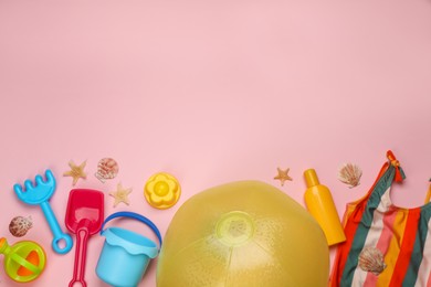Photo of Flat lay composition with beach ball and sand toys on pink background. Space for text