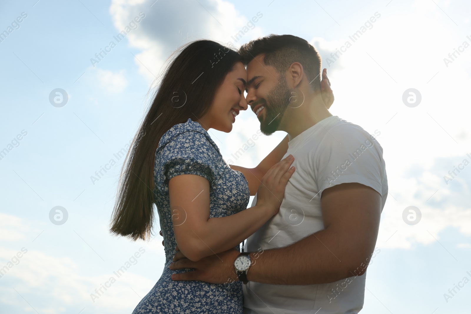 Photo of Romantic date. Beautiful couple spending time together against blue sky