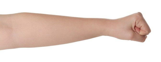 Photo of Playing rock, paper and scissors. Woman showing fist on white background, closeup