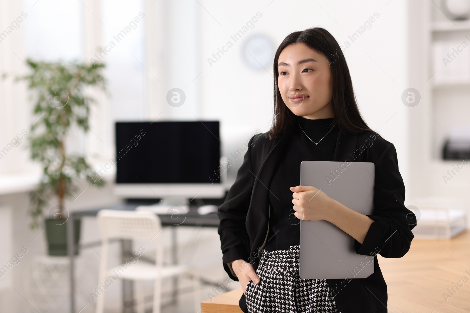 Photo of Portrait of beautiful businesswoman with laptop in office. Space for text