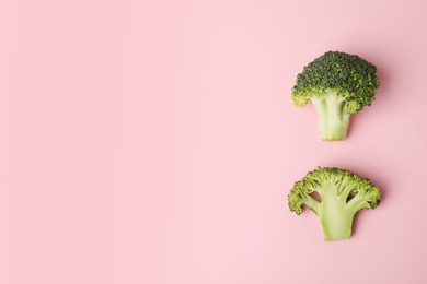 Photo of Flat lay composition with fresh green broccoli and space for text on color background