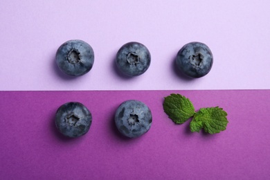 Flat lay composition with tasty blueberry on color background