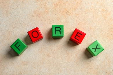 Photo of Word Forex made with colorful cubes on light table, flat lay