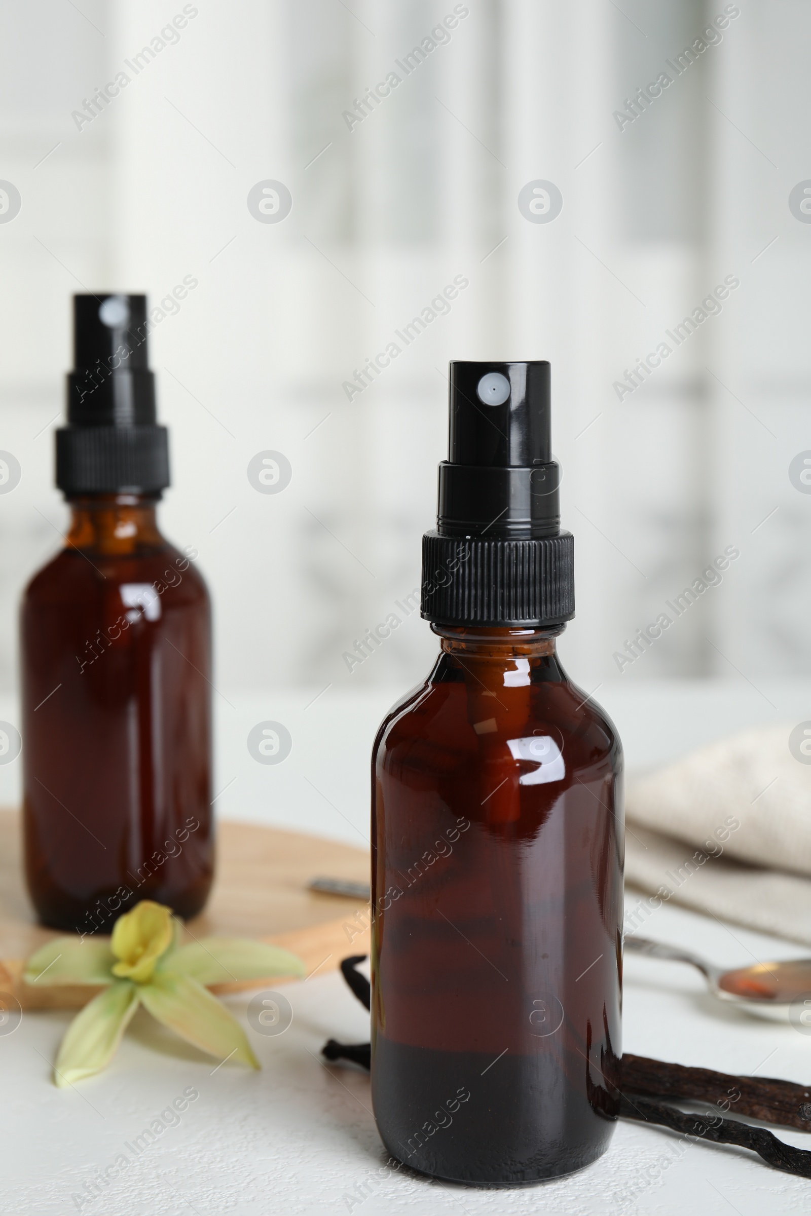 Photo of Aromatic homemade vanilla extract on white table