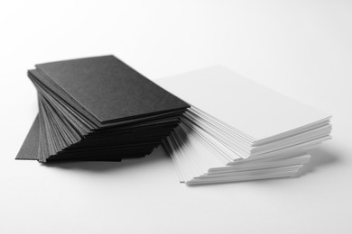 Photo of Many blank business cards on white background, closeup. Mockup for design