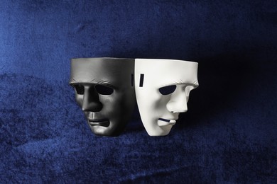 Theater arts. Two masks on blue fabric, top view