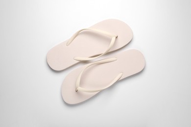 Photo of Stylish flip flops on white background, top view