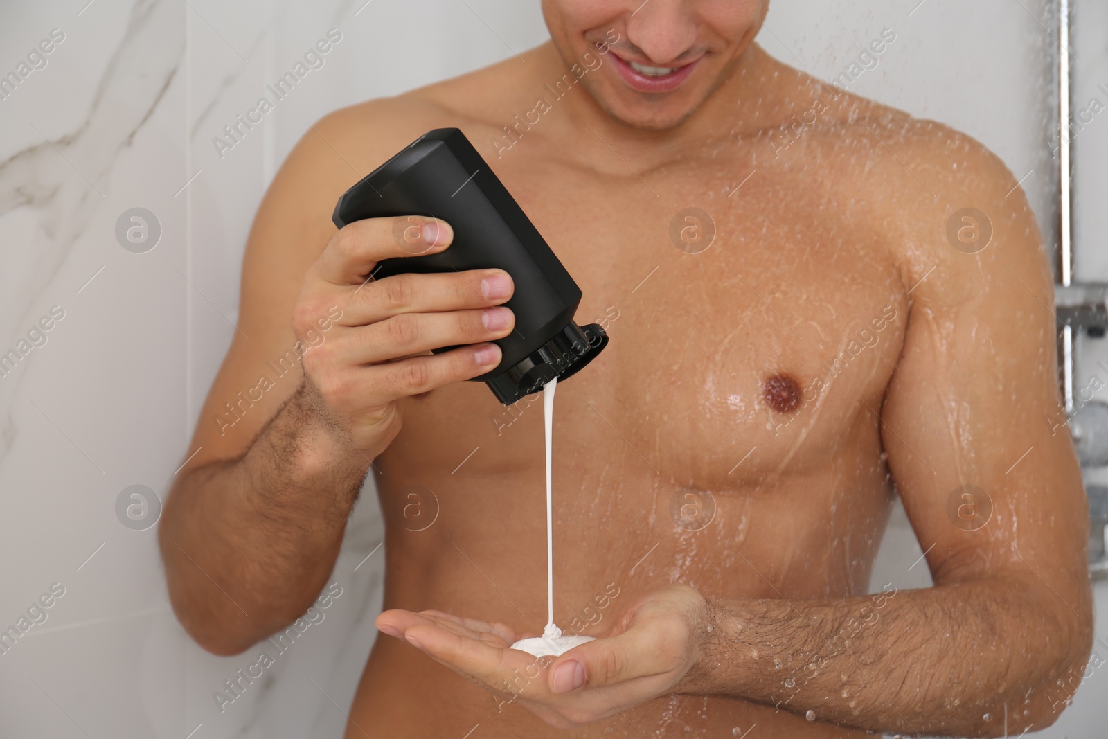 Photo of Man applying gel in shower at home, closeup
